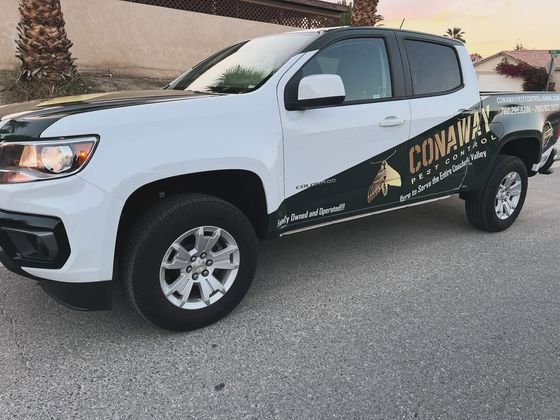 A Conaway Pest Control service truck with the company wrap, parked at a Coachella Valley property